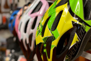 Selection of different coloured cycle helmets inside Biketrax shop