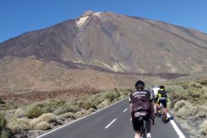 Biketrax sponsored cyclist riding on a road towards a mountain